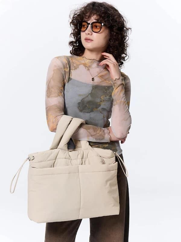 GU - Puff Drawstring Shoulder Bag (Category: Sling Bags) located in Pasig City. Submitted by nix_21 (Listing ID 1345426229, Image 3). Description: Add a touch of style and convenience to your outfit with our Puff Drawstring Shoulder Bag from GU Japan. Spacious, functional, and perfect for carrying your essentials with ease. 🌟 💡 Details: 🔸 Colors: Beige (sold) & Black (available) 🔸 Price: ₱1,250 (on-hand, PH) 📏 Size: Length: 30 cm Width (Bott