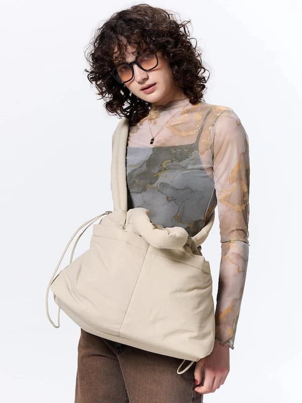GU - Puff Drawstring Shoulder Bag (Category: Sling Bags) located in Pasig City. Submitted by nix_21 (Listing ID 1345426229, Image 2). Description: Add a touch of style and convenience to your outfit with our Puff Drawstring Shoulder Bag from GU Japan. Spacious, functional, and perfect for carrying your essentials with ease. 🌟 💡 Details: 🔸 Colors: Beige (sold) & Black (available) 🔸 Price: ₱1,250 (on-hand, PH) 📏 Size: Length: 30 cm Width (Bott