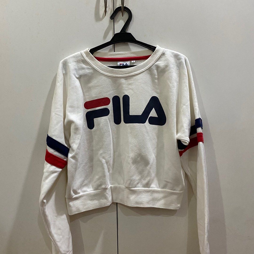 White FILA Sweatshirt (Category: Longsleeves) located in Antipolo. Submitted by de.klutter (Listing ID 1345403658, Image 1). Description: White FILA Sporty Cropped Sweatshirt / Jumper - Size: Women’s Medium CONDITION: Pre-loved, 7/10. Has a few bleach marks on the sleeve stripes on one sleeve (see photo) RFS: Decluttering PM for additional pics/info!.