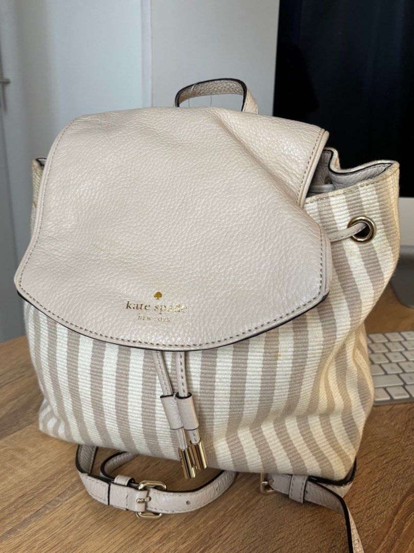 Kate Spade Backpack (Category: Luxury Bags & Wallets) located in Las Pinas. Submitted by eggspresso (Listing ID 1345681929, Image 3). Description: Used 2x then stored Please check photos for some stains/discoloration due to storage 10” W x 9.5” H x 4” D Drawstring closure. Lined. Interior zip pocket. Drawstring closure. Lined. Interior zip pocket. Front gold foil logo. Top loop. Adjustable dual straps to be carried as a backpack.