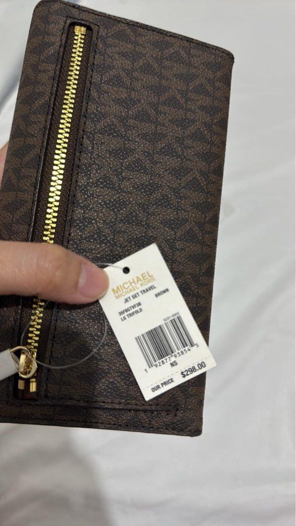 Michael Kors trifold wallet (Category: Luxury Bags & Wallets) located in Bulacan. Submitted by reloveandrepeat (Listing ID 1345515233, Image 1). Description: Bought in Canada rfs: decluttering with paper bag and tag.