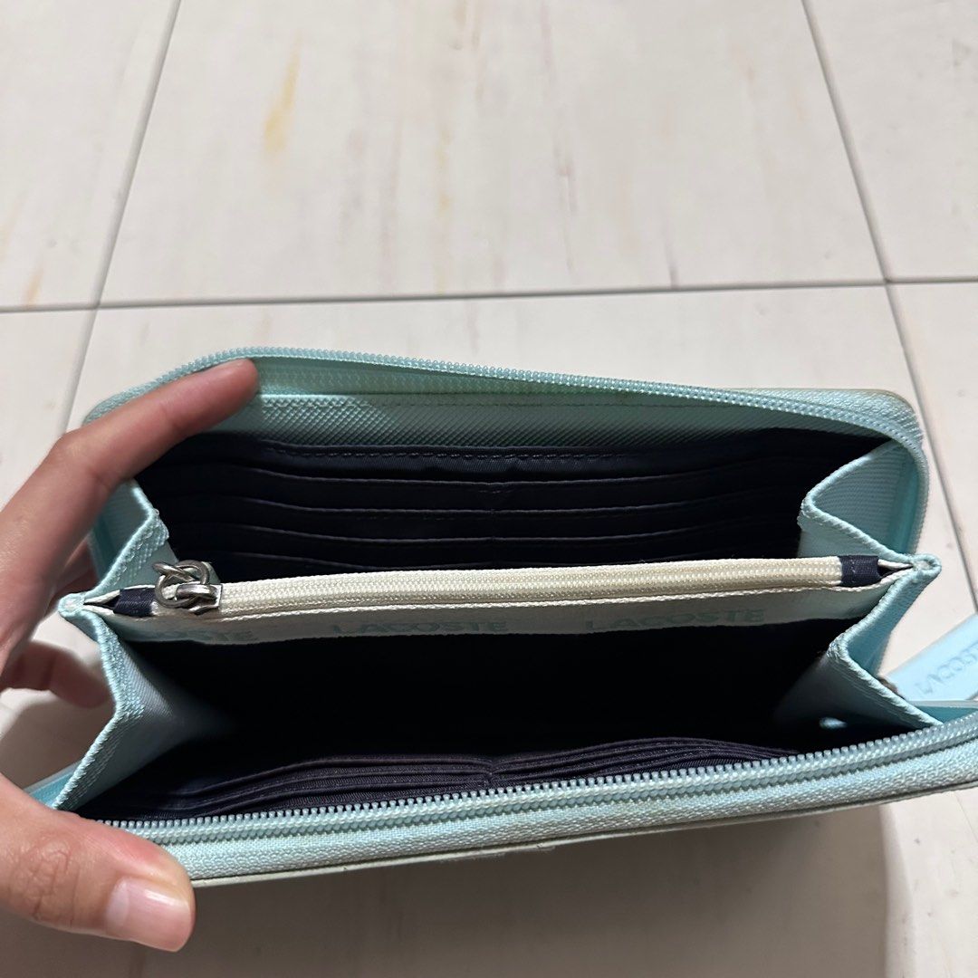 LACOSTE Turquoise Leather Large Wallet (Category: Wallets & Card holders) located in Manila. Submitted by catchim (Listing ID 1346074093, Image 3). Description: Preloved wallet 🩵 •Zip Closure, 12 card slots, and zipped coin compartment Some Issues. GOOD CONDITION •signs of storage (staining - needs deep cleaning) PM for more details!.