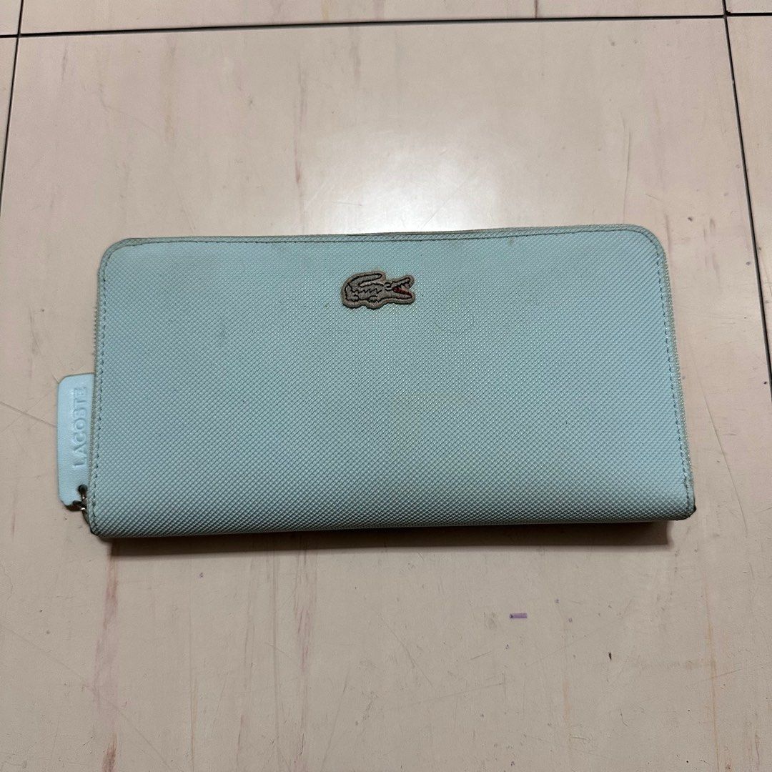 LACOSTE Turquoise Leather Large Wallet (Category: Wallets & Card holders) located in Manila. Submitted by catchim (Listing ID 1346074093, Image 1). Description: Preloved wallet 🩵 •Zip Closure, 12 card slots, and zipped coin compartment Some Issues. GOOD CONDITION •signs of storage (staining - needs deep cleaning) PM for more details!.