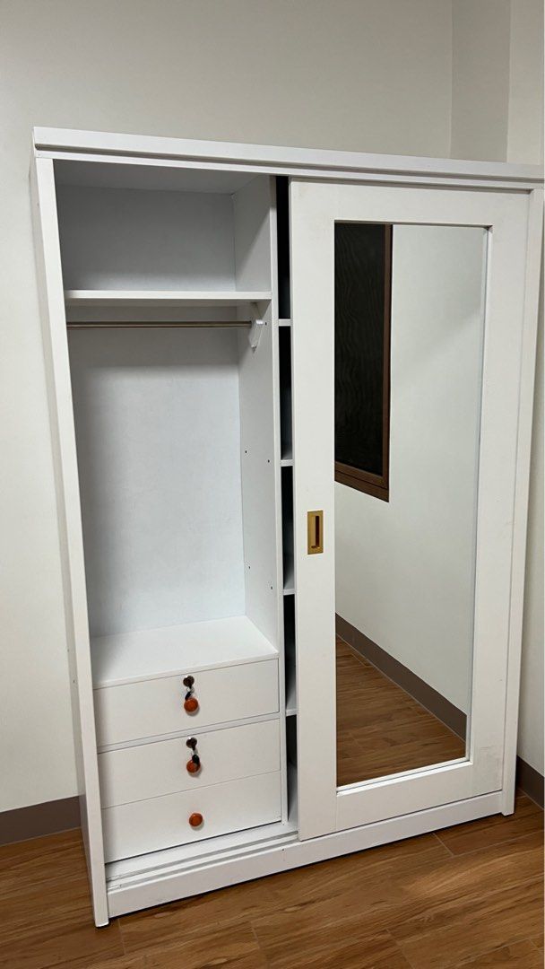 Wooden Sliding Wardrobe Cabinet (Category: Shelves, Cabinets & Racks) located in Makati City. Submitted by berniebones (Listing ID 1346071384, Image 3). Description: Wardrobe Cabinet Color: White Material: Wood Size: 122 x 42 x 180 cm (LWH) Features: -slide to open and close -with 2 large mirrors -3 wide drawers (2 of which can be lock with keys) -4 small drawers -made of wood but not sure on what exact type of wood *The cabinet looks small in pi