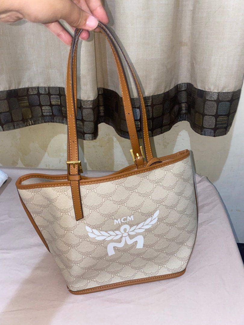Authentic MCM Mini Himmel Shopper Tote Bag (Category: Luxury Bags & Wallets) located in General Tinio. Submitted by amangahas811051 (Listing ID 1346472841, Image 1). Description: Authentic MCM Mini Himmel Shopper in Lauretos Approximately 5.1 x 8.7 x 8.5 inches Handle drop: 7.1” Adjustable leather handles YKK Zipper can be seen in the last photo Comes with Dust Bag Box nowhere to found Good as new, no dents at all.