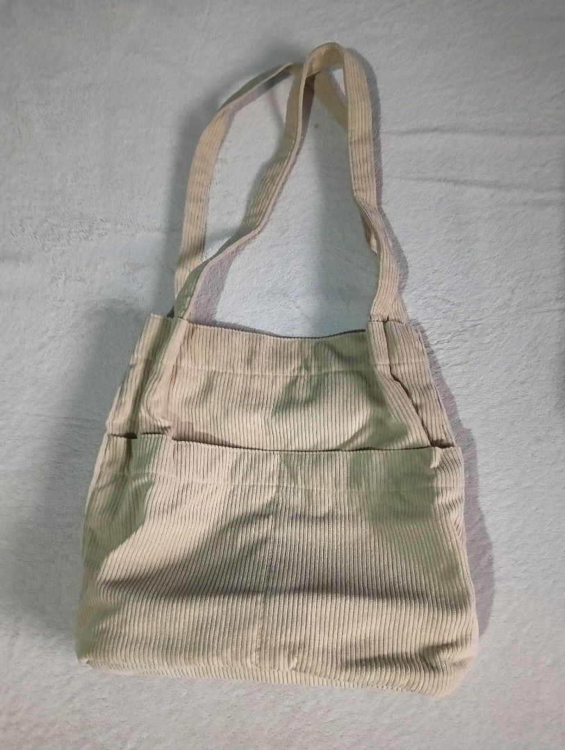 Corduroy tote bag (Category: Tote Bags) located in Marilao. Submitted by keyset (Listing ID 1346388293, Image 3). Description: Like new, only used once • Bag dimensions: 13in x 14in x 4.5in • Strap length: 11.5in • Outside: two open pockets • Inside: two open pockets + one zippered pocket *Clothes are only used for styling ☞ MOP: Gcash, Maya, Maribank, Unionbank ☞ MOD: Lalamove, J&T ☞ Buyer shoulders shipping fee 📍 Marilao, Bulacan 🚫 No Sh0pee 
