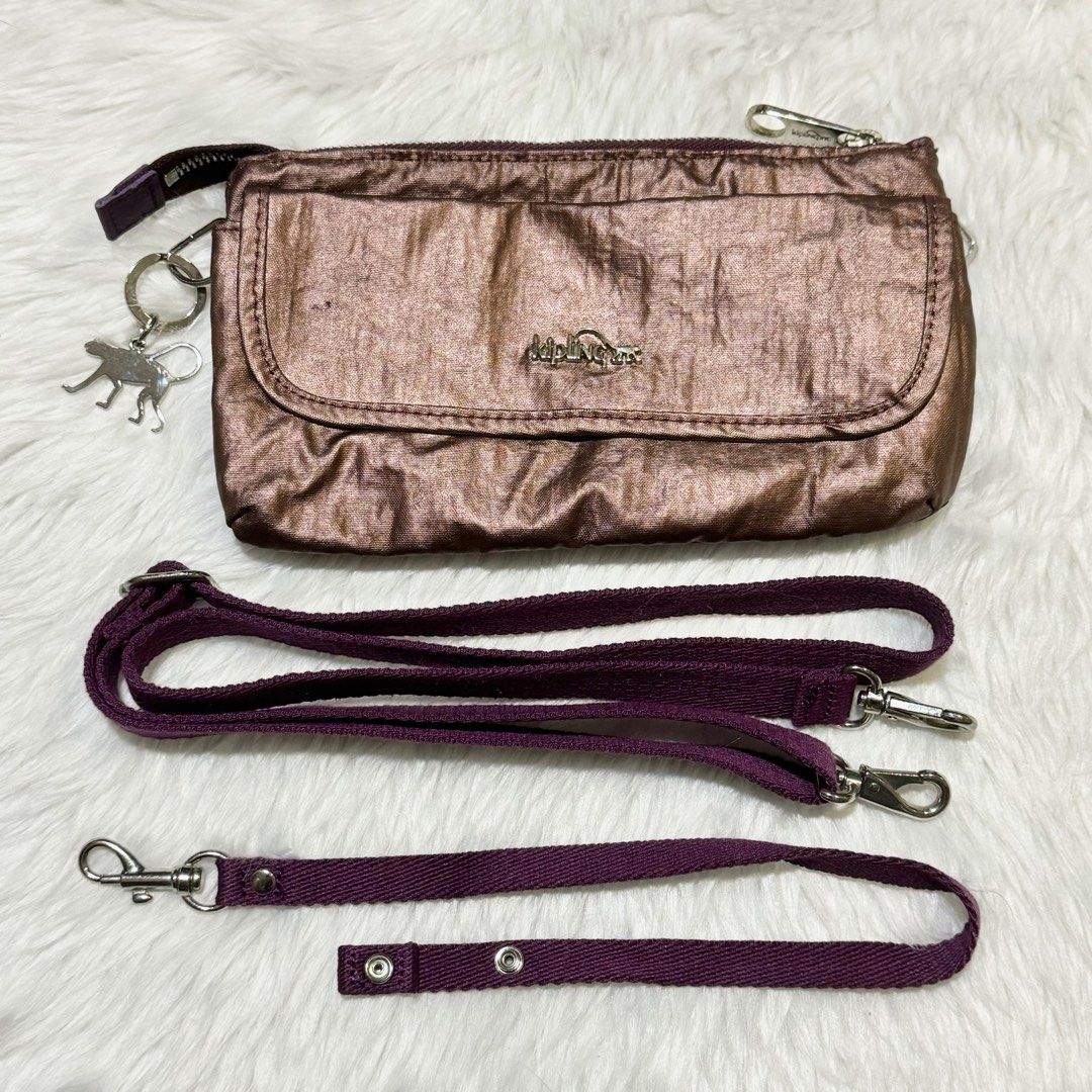 KIPLING Small Metallic Purple Cross-body Bag (Category: Cross-body Bags) located in Manila. Submitted by adoptables4u (Listing ID 1346297459, Image 2). Description: Kipling Cross-body Bag 🦧 - With original kipling tag 🏷️ Please see uploaded imgs for flaws ✨ Product color: Metallic Purple Size (mm): 130 x 230 x 50 Material: Nylon & Polyester 590 yuan SRP feel free to chat for inquiries :) .