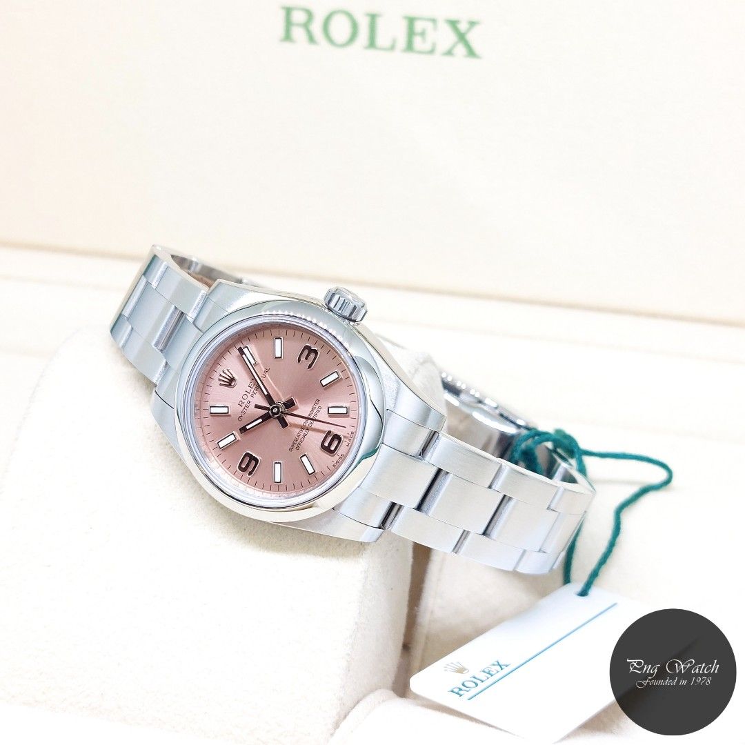 Rolex 26mm Pink Arabic Dial Oyster Perpetual REF: 176200 (Box, Card & Tag-2016) (Category: Watches) located in Singapore. Submitted by pngwatchdealer (Listing ID 1346338621, Image 1). Description: [SPECIFICATIONS] **Watch comes in full option (Box, Card & Tag)** Brand: Rolex Model: Oyster Perpetual 26mm Pink Arabic Dial (REF: 176200)(AN)(16)(O) Movement: Automatic (Self-Winding) Functions and Features: Hours, Minutes and Seconds (CASE) Case Mater