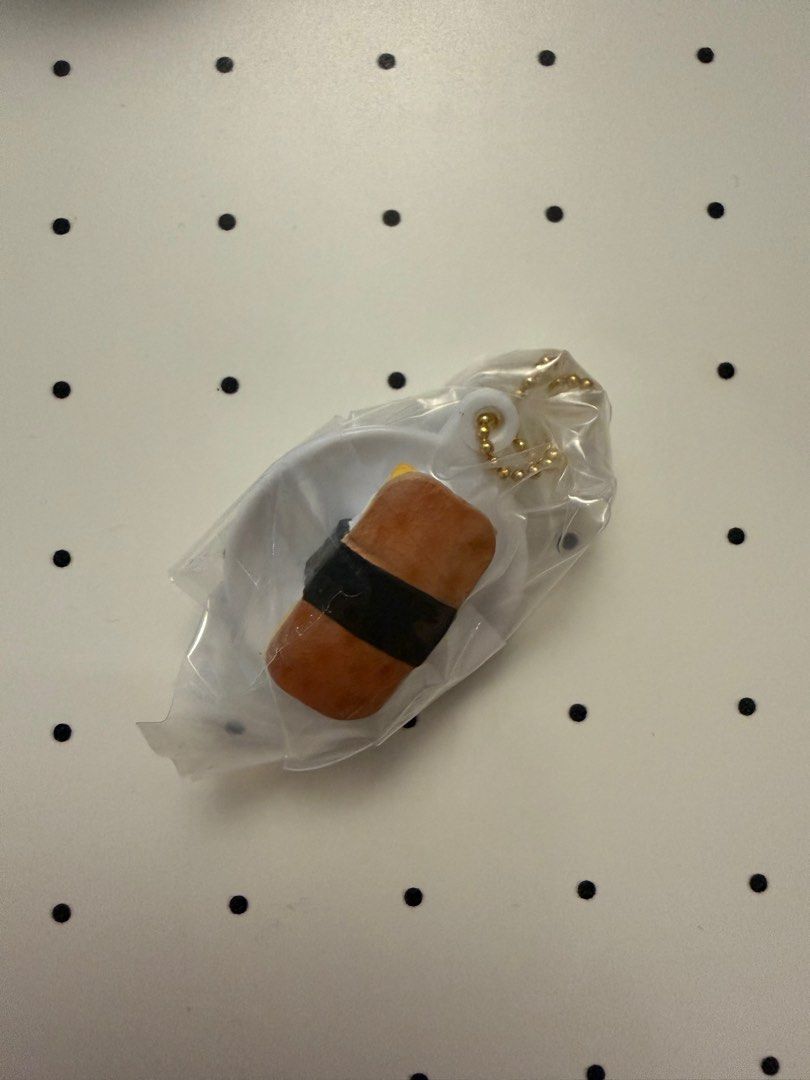 Bandai SPAM MINIATURE CHARM - Spam Sushi (Category: Designer & Blind Box Toys) located in Quezon City. Submitted by neep.bnb (Listing ID 1395758993, Image 2). Description: SPAM MINIATURE CHARM - Spam Sushi Brand New RFS: Not my Prio - Bandai Spam Miniature Charm - Adorable Spam sushi design - Comes in original clear capsule - Attached to a gold-colored chain - Includes a Spam tag - Packaging back shows other designs in the collection.