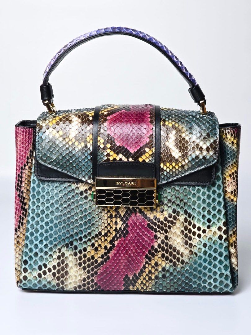 Bvlgari Serpenti Viper Top Handle Bag Multicolored (Category: Luxury Bags & Wallets) located in Pandi. Submitted by luximperium (Listing ID 1395749783, Image 2). Description: Color: Multicolor (Magenta, Purple, Blue Green, Black, White, Beige) Includes: Dust bag, Detachable Shoulder Strap, Dust bag for the strap, Rain Bag Cover, Care Card Material: Leather, Python (Exterior), Leather (Interior) Size: Medium Dimensions: L (24cm), H (18cm), W (9cm)