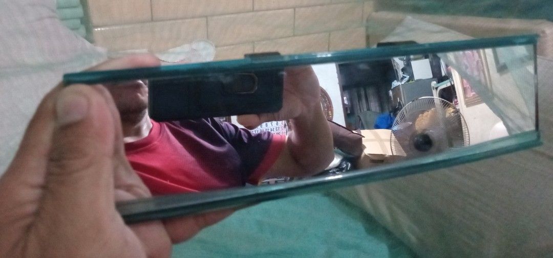 Car Interior Rearview Mirror (Category: Body Parts and Accessories) located in Valenzuela. Submitted by consjavier74 (Listing ID 1395804932, Image 1). Description: - Rectangular rearview mirror - Dark frame - Provides a clear view of the car's interior - Easy to install.