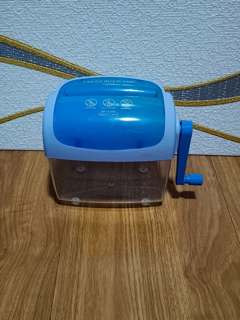 CS296B Cross Cut Hand Shredder (Category: Office & Business Technology) located in Makati City. Submitted by nyxhemera26 (Listing ID 1395915878, Image 1). Description: - CS296B Manual Cross-Cut Paper Shredder - Features a blue and clear plastic body - Operated with a hand crank - Designed for personal use - Shreds paper into small, secure pieces - Box shows design and features.