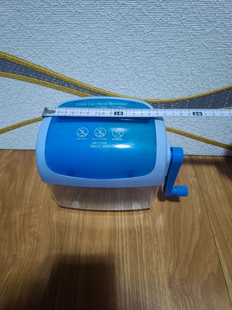 CS296B Cross Cut Hand Shredder (Category: Office & Business Technology) located in Makati City. Submitted by nyxhemera26 (Listing ID 1395915878, Image 3). Description: - CS296B Manual Cross-Cut Paper Shredder - Features a blue and clear plastic body - Operated with a hand crank - Designed for personal use - Shreds paper into small, secure pieces - Box shows design and features.