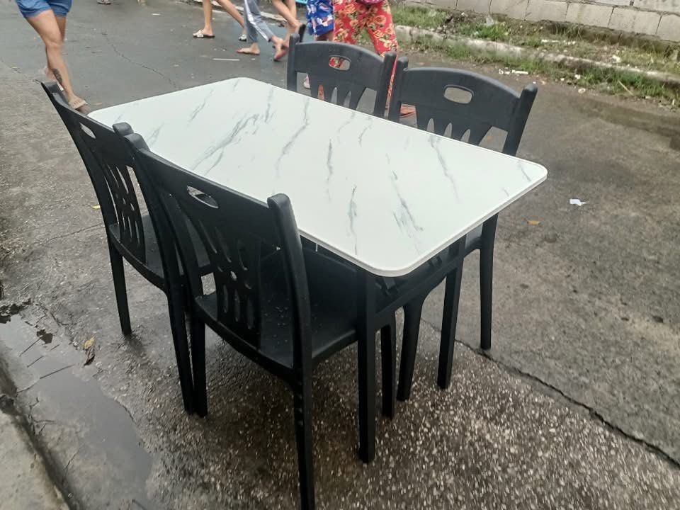 Dining Table Set with 4 Chairs (Category: Tables & Sets) located in Quezon City. Submitted by joycemanahan (Listing ID 1395846615, Image 1). Description: - Durable dining set - Rectangular table with marble-like surface - Includes four plastic chairs - Available colors: Black and White - Ideal for small spaces and apartments - Great for everyday use Quezon city location Cash on delivery 09197697979.