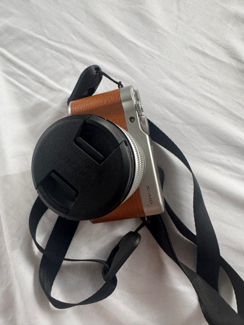 Fujifilm X-A10 Camera with Lens (Category: Cameras) located in La Paz. Submitted by sugarnspice123 (Listing ID 1395909704, Image 2). Description: - Fujifilm X-A10 camera - Silver body with brown grip - Comes with camera strap - Includes black lens cap - Rechargeable Battery - USB cable & Adapter (orig) RFS: Need funds MOP: BDO/Gcash Issue is yung kabitan ng tripod na stuck po kasi yung before na nilagay na tripod pero matatangal pa naman siya. Qu