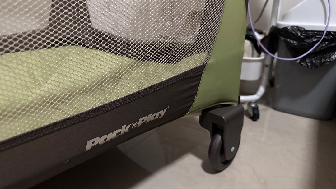 Graco Pack 'n Play Playard (Category: Cots & Cribs) located in Quezon City. Submitted by declutteringmj (Listing ID 1395881167, Image 3). Description: - Graco Pack 'n Play playard - Green and brown color scheme - Mesh side for visibility - Includes a padded mattress - Foldable design for easy storage - Wheels for easy movement - Graco logo visible Has some holes that's why selling cheap. Just washed the whole crib bec my baby just used it. For Pi