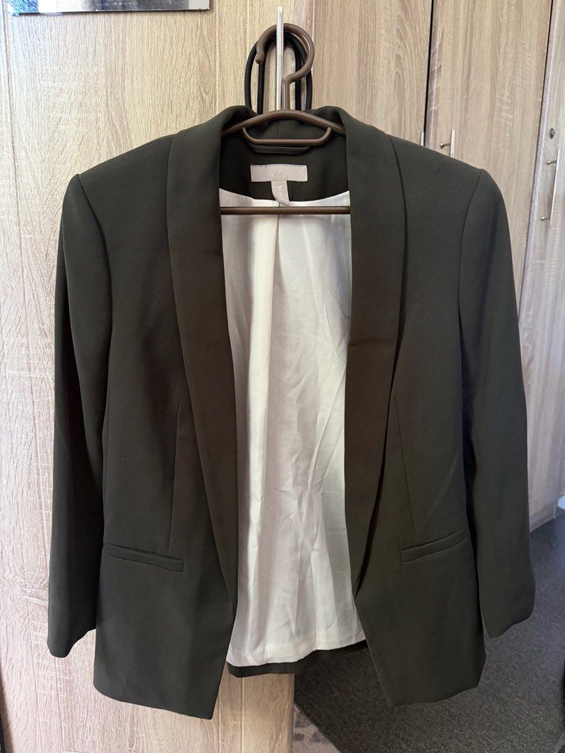 H&M Blazer - Olive Green (Category: Coats, Jackets and Outerwear) located in Antipolo. Submitted by articlesbyeve (Listing ID 1395793249, Image 1). Description: - H&M Olive Green Blazer - Size: EU 32, UK 4, CN 150/76A - Features: - Classic design - White inner lining - Notched lapel - Two front pockets - Perfect for adding a touch of sophistication..