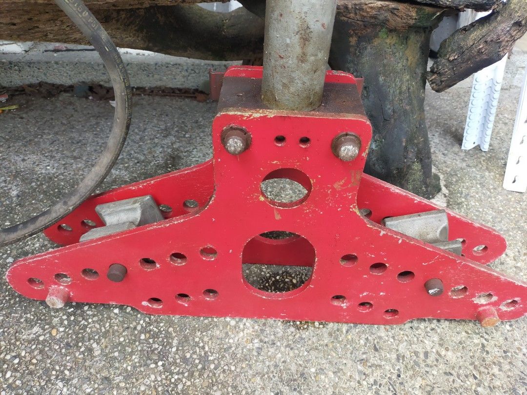 Hydraulic Pipe Bender (Category: Construction Tools & Equipment) located in Taytay. Submitted by archie2427 (Listing ID 1395893307, Image 3). Description: - Hydraulic pipe bender for bending pipes. - Features a sturdy red base with multiple holes. - Includes a central support and hydraulic pump. - Comes with connecting hoses. - Designed for heavy-duty use. - As is - For restoration or maybe repair.
