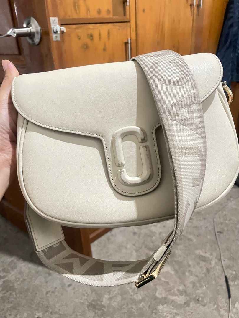 Marc Jacobs The J Marc Shoulder Bag (Category: Luxury Bags & Wallets) located in Bacolod City. Submitted by juvy.sanchez (Listing ID 1395858081, Image 1). Description: - Cream-colored shoulder bag - Wide, branded strap - Flap closure with Marc Jacobs logo - Light-colored interior lining - Gold-toned chain and hardware - Rounded shape, structured design with sign of usage pls check the 2nd to the last picture .