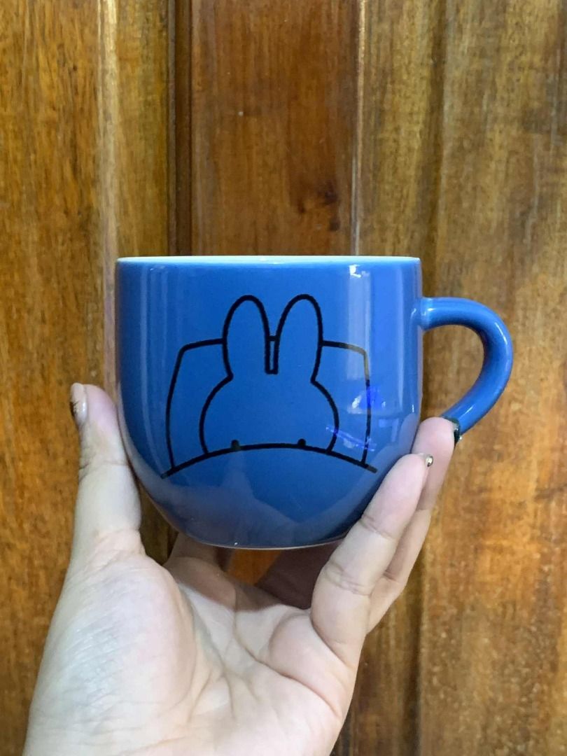 Miffy 60 Years Anniversary Mug (Category: Coffee & Tea Tableware) located in Manila. Submitted by jkaye890 (Listing ID 1395829042, Image 1). Description: - Miffy 60th Anniversary Mug - Blue exterior with Miffy design - Features "60 years with miffy" text - Interior Miffy illustration - Comfortable handle - Never Used (Japan Surplus).