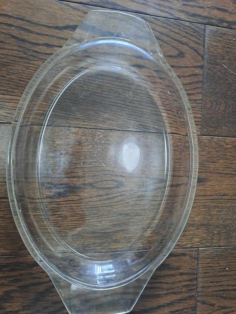 Oval Glass Baking Dish with Handles (Category: Bakeware) located in Manila. Submitted by joanbalde39643 (Listing ID 1395834393, Image 2). Description: - Oval glass baking dish - Transparent glass material - Features integrated handles - Suitable for baking and serving - Smooth, rounded shape.