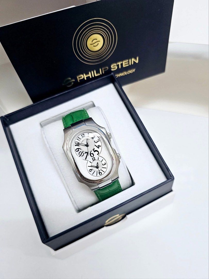 Philip Stein Dual Time Zone Watch Large (Category: Luxury Watches) located in Pateros City. Submitted by omniabeautyph. (Listing ID 1395820823, Image 1). Description: - Philip Stein watch - Dual time zone display - White dial with silver hands and markers - Stainless steel case - Green leather strap - Comes with original box.