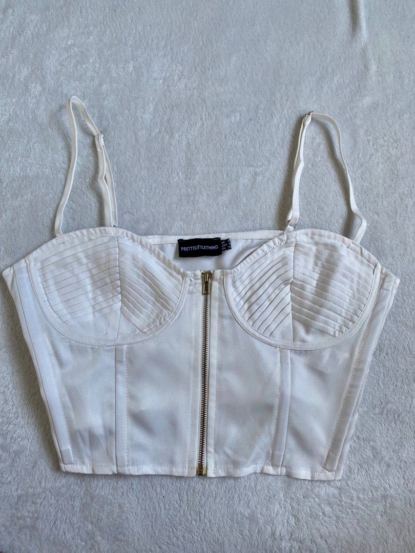 Corset Top (Category: Sleeveless) located in Cavite. Submitted by jaydaascollection (Listing ID 1395884901, Image 1). Description: White corset top from PrettyLittleThing. Features a zip-up front and adjustable straps. The top has pleated detailing on the bust. The size is UK 8, USA 4, and EUR 36..