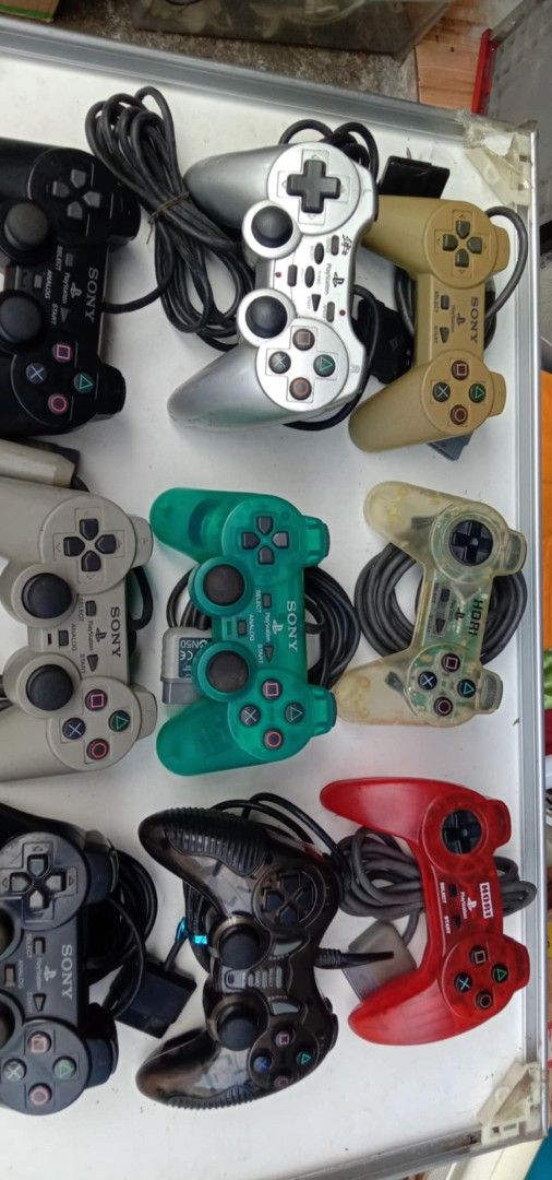 Sony PlayStation 2 Controllers (Category: Controllers) located in Quezon City. Submitted by jpnvintageonline (Listing ID 1395754322, Image 2). Description: - PlayStation 2 controllers - Colors: Black, Silver, Green, Red, Beige - Wired controllers - Standard PlayStation 2 button layout.