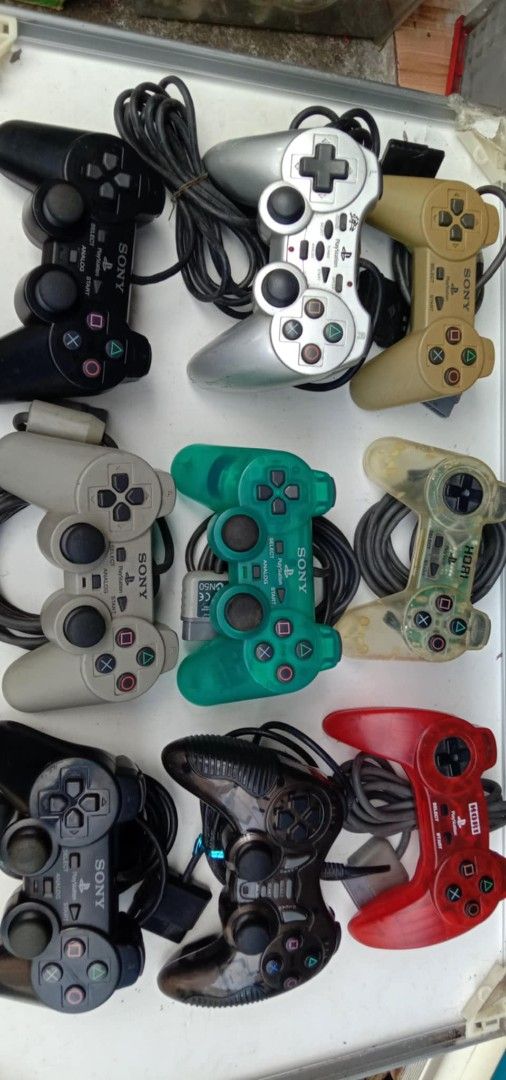 Sony PlayStation 2 Controllers (Category: Controllers) located in Quezon City. Submitted by jpnvintageonline (Listing ID 1395754322, Image 1). Description: - PlayStation 2 controllers - Colors: Black, Silver, Green, Red, Beige - Wired controllers - Standard PlayStation 2 button layout.