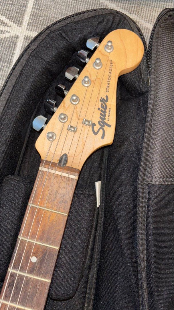 Squier Stratocaster by Fender (Category: Musical Instruments) located in Pasig City. Submitted by unwanteditemsfrommycloset (Listing ID 1395765307, Image 2). Description: 🔥used but not abused 🔥tried to learn how to play but gave up after 3 months… never used it since 🔥no hidden issues 🔥comes with fender cords (with extra cord), fender strap, and capo rfs: not in use anymore:( Pm if interested!!.