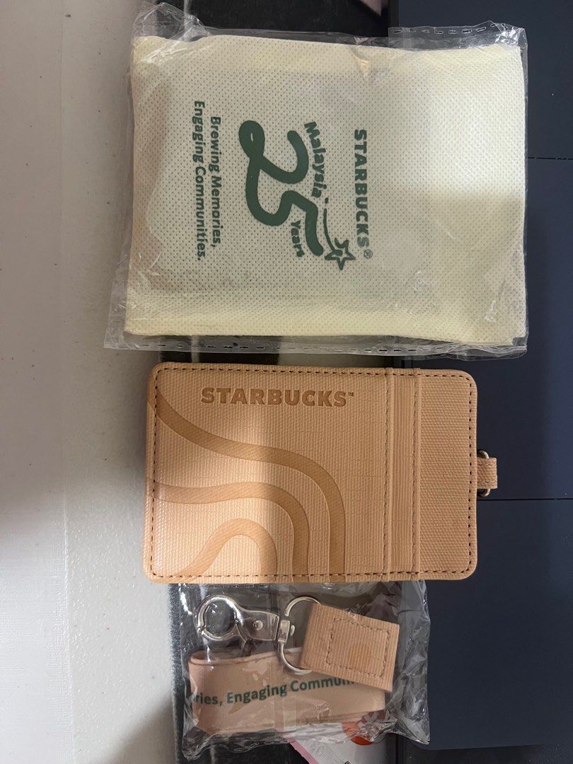 Starbucks 25th Anniversary Card Holder (Category: Wallets & Card holders) located in San Fernando. Submitted by leonag (Listing ID 1395892145, Image 2). Description: - Starbucks 25th Anniversary Card Holder - Special Edition - Beige color - Includes lanyard - Comes with a pouch - Features Starbucks logo and anniversary details - Brand new, in original packaging.