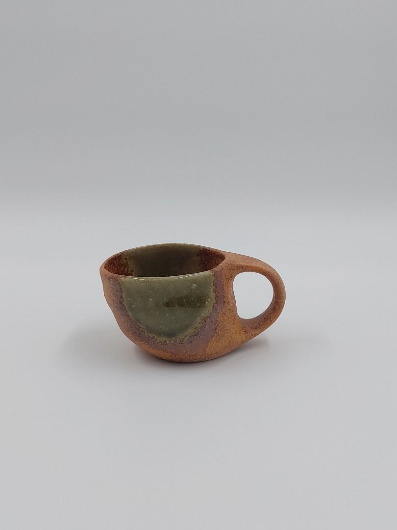 Stoneware Cup and Saucer Set (Category: Coffee & Tea Tableware) located in Quezon City. Submitted by curated.stoneware.ph. (Listing ID 1395776508, Image 3). Description: - Stoneware cup and saucer set - Unique design - Two-tone green and brown color scheme - Cup features a distinctive handle - Saucer has an organic shape - Ideal for coffee or tea - Adds artistry to your table setting.