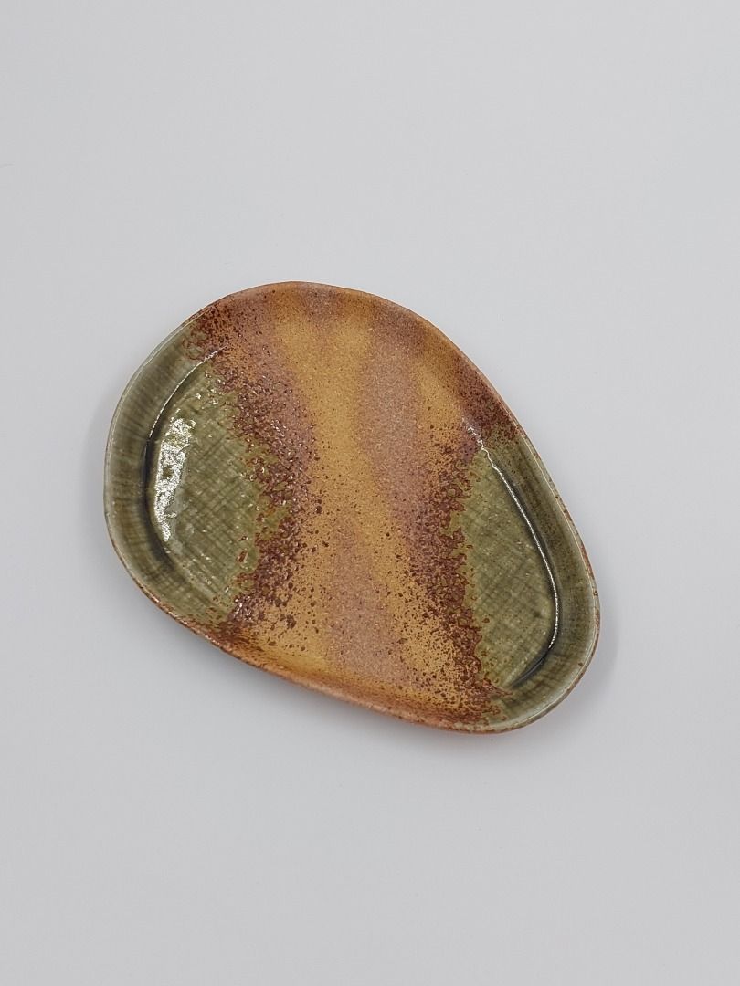 Stoneware Cup and Saucer Set (Category: Coffee & Tea Tableware) located in Quezon City. Submitted by curated.stoneware.ph. (Listing ID 1395776508, Image 2). Description: - Stoneware cup and saucer set - Unique design - Two-tone green and brown color scheme - Cup features a distinctive handle - Saucer has an organic shape - Ideal for coffee or tea - Adds artistry to your table setting.
