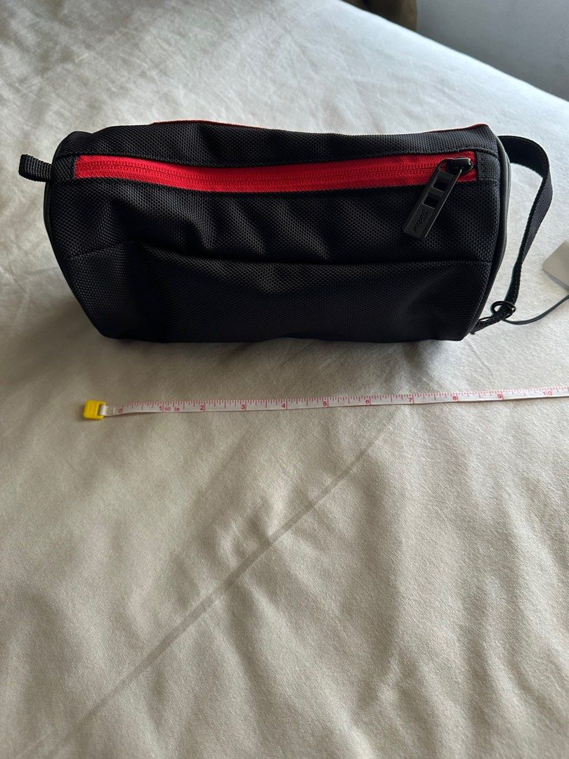 Titleist Golf Accessory Bag (Category: Golf) located in Quezon City. Submitted by essief (Listing ID 1395747188, Image 2). Description: - Titleist golf accessory bag - Black and red design - Zipper closure - Includes a handle - Comes with a tag - Titleist logo on the side - New and unused.