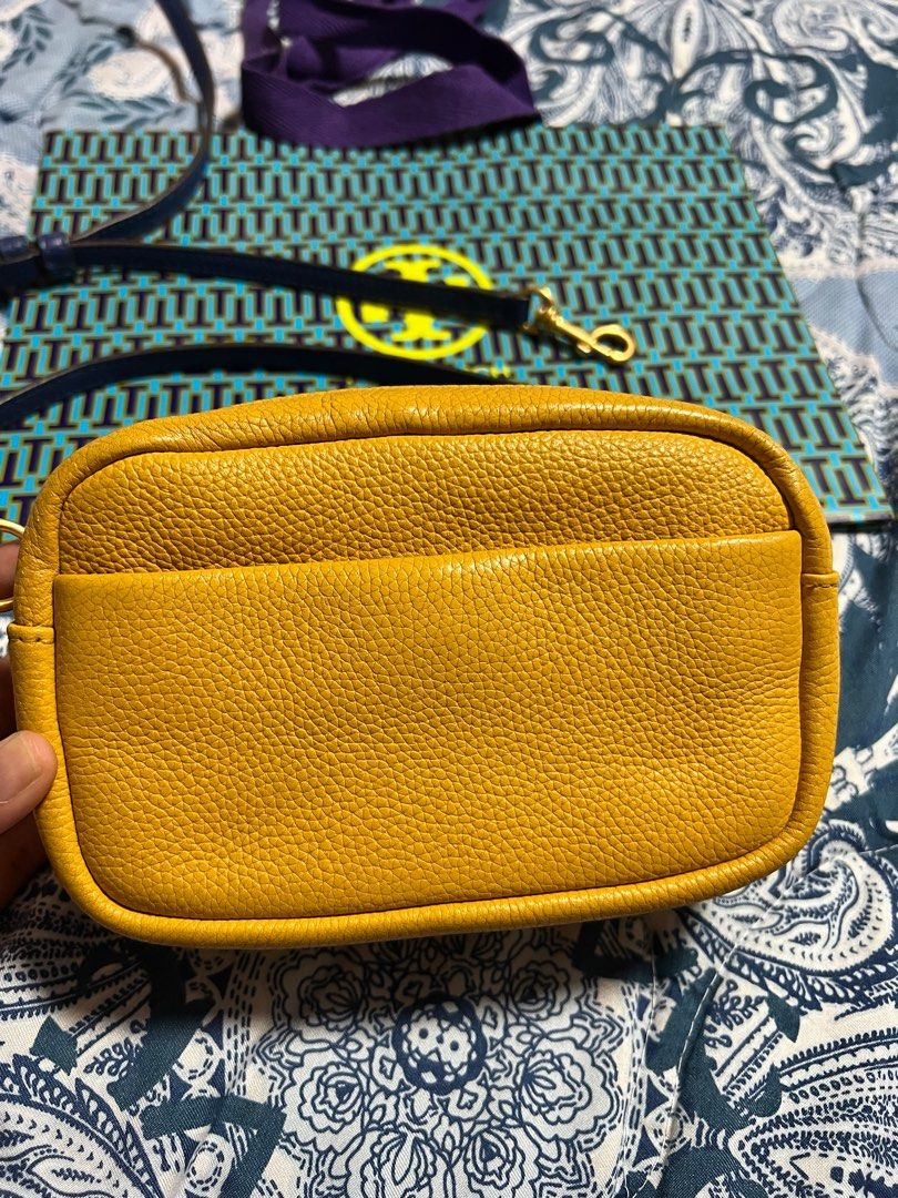 Tory Burch Perry Bombe Mini (Category: Luxury Bags & Wallets) located in Las Pinas. Submitted by anakim (Listing ID 1395747488, Image 2). Description: - Authentic Tory Burch Perry Bombe Mini crossbody bag - Color: Mustard Yellow - Features: Front pocket, dual zipper closure, embossed logo - Includes: Detachable crossbody strap, dustbag, paper bag - Interior: Lined with matching yellow fabric - Made in the Philippines.
