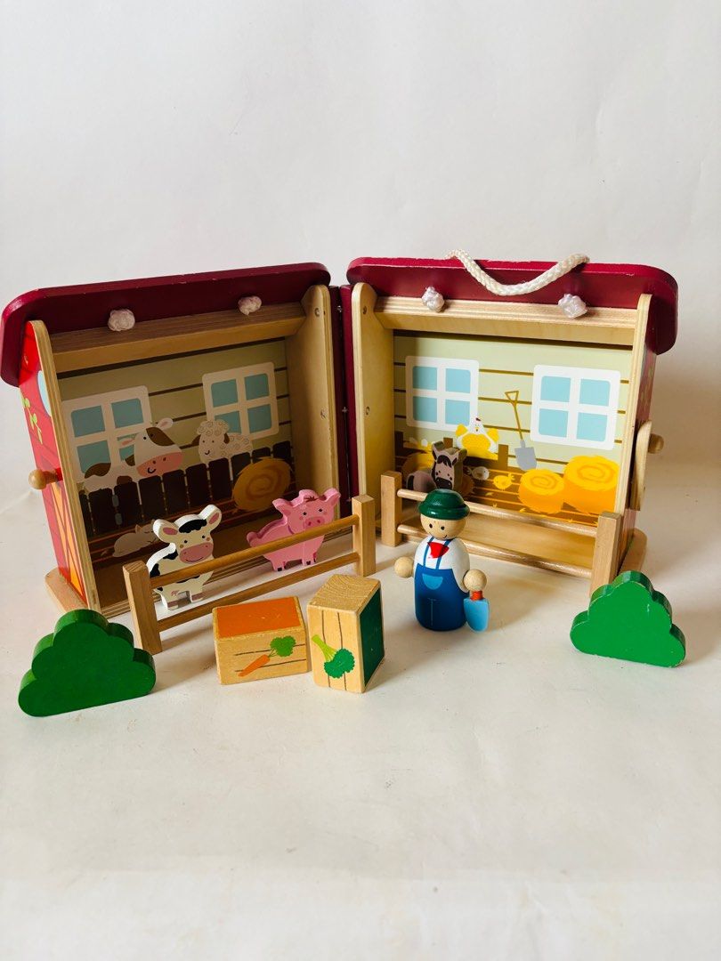 Wooden Farm Barn Playset (Category: Kids Toys) located in Quezon City. Submitted by tilllabloo (Listing ID 1395919390, Image 2). Description: - Wooden farm barn playset - Features a red barn with a handle - Opens to reveal a farm scene .