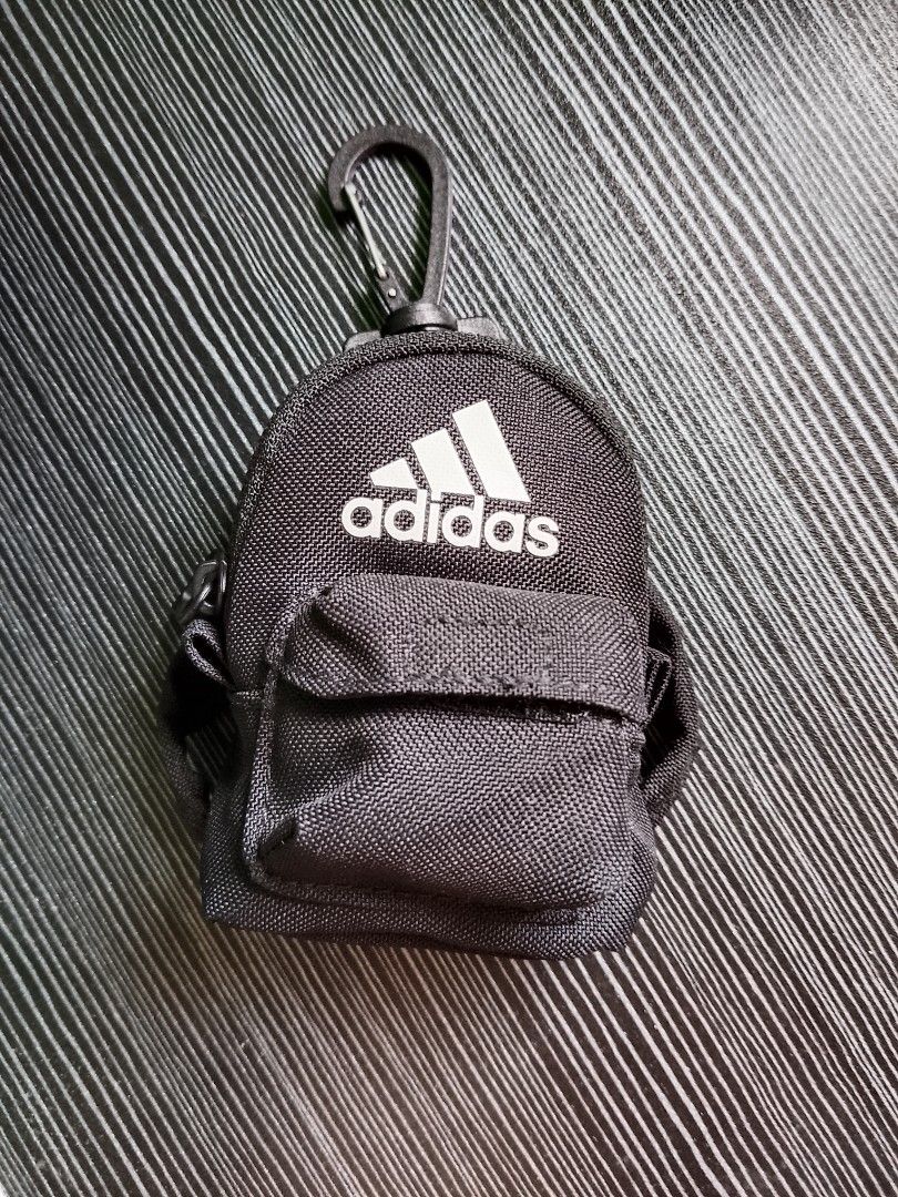 Original Adidas Black Pouch with Carabiner (Category: Purses & Pouches) located in Quezon City. Submitted by osaki.drew (Listing ID 1397459332, Image 1). Description: - Adidas black pouch with Eco Bag - Features the Adidas logo - Small front pocket - Zipper closure - Carabiner clip for easy attachment - Durable fabric - Interior tag - Can use as Bag charm, Coin Purse or Earphone Case..