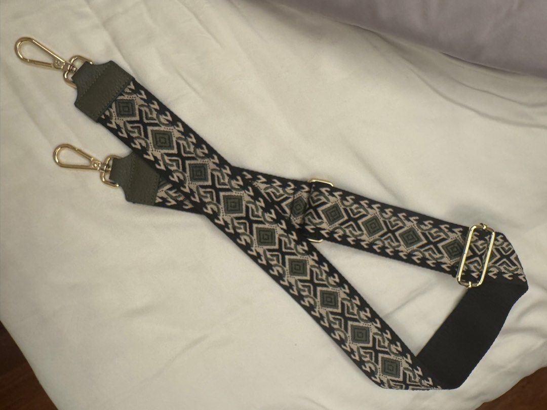 Adjustable leather Bag Strap with Geometric Pattern (Category: Cross-body Bags) located in Makati City. Submitted by masaca (Listing ID 1397537220, Image 1). Description: - Stylish bag strap - Features a unique geometric pattern - Gold-colored clasps - Dark green leather accents - Adjustable length - Easy attachment - Perfect bag accessory.