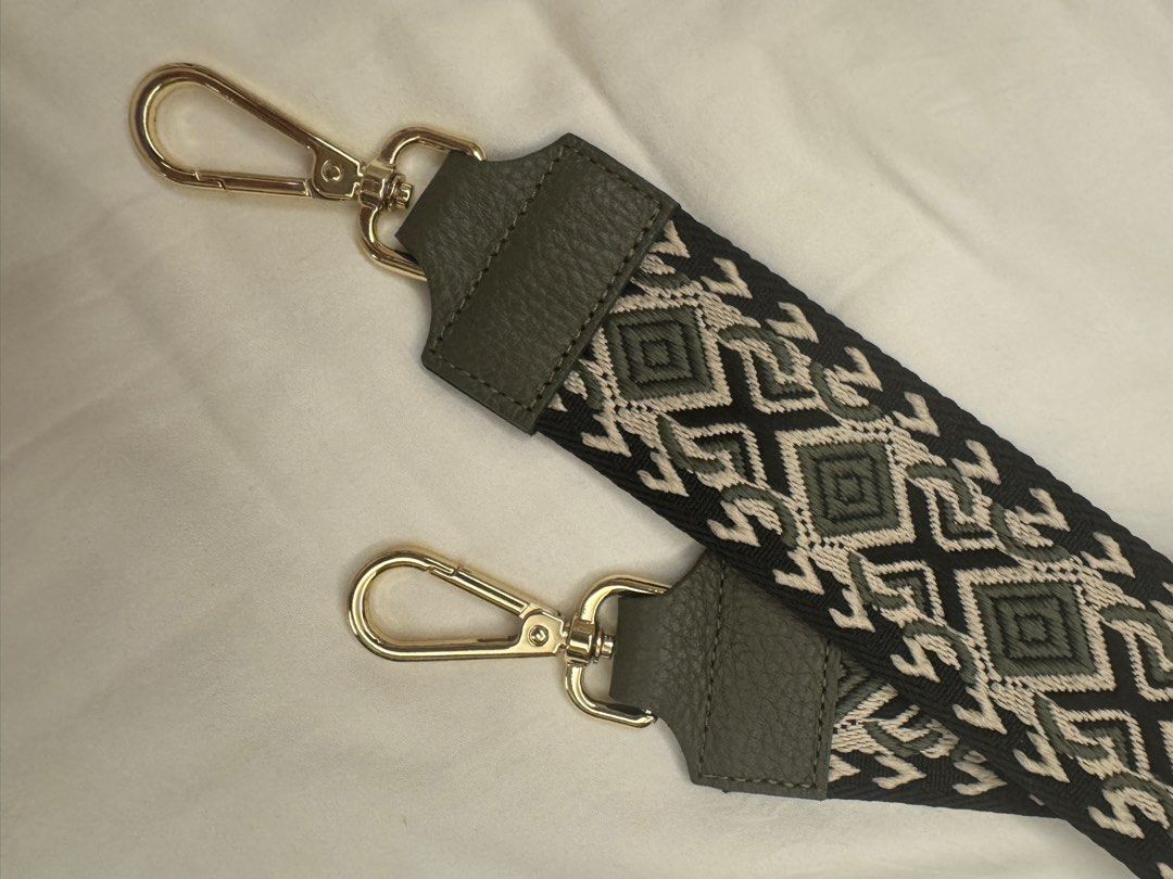 Adjustable leather Bag Strap with Geometric Pattern (Category: Cross-body Bags) located in Makati City. Submitted by masaca (Listing ID 1397537220, Image 2). Description: - Stylish bag strap - Features a unique geometric pattern - Gold-colored clasps - Dark green leather accents - Adjustable length - Easy attachment - Perfect bag accessory.