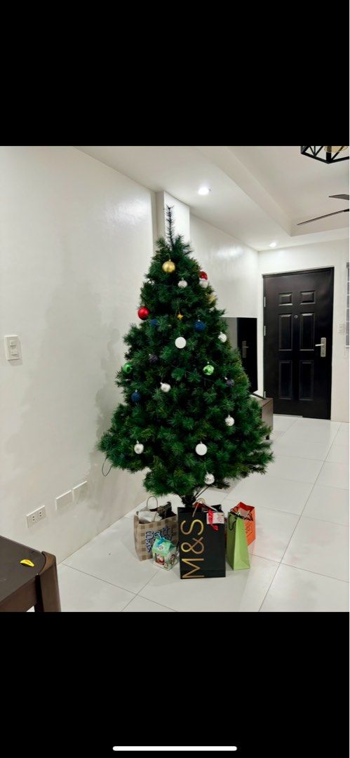 Artificial Christmas Tree with Ornaments (Category: Other Home Decor) located in Quezon City. Submitted by kdp_2021 (Listing ID 1397541459, Image 2). Description: - Ready for Christmas! - Pre-lit with lights - Comes with pre-attached ornaments - Vibrant green color - Standard size - Perfect for a festive holiday atmosphere.
