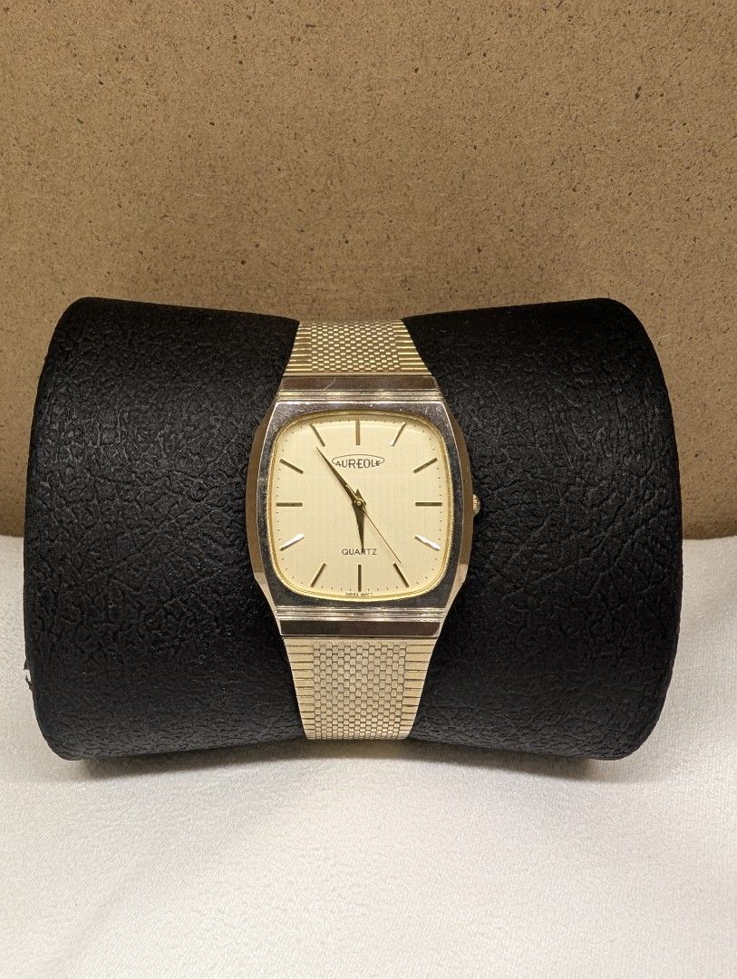 Aureole Quartz Watch SW-E229 (Category: Luxury Watches) located in Muntinlupa City. Submitted by luckyfrogzone (Listing ID 1397509967, Image 1). Description: This is a beautiful vintage quartz watch from the historic Swiss brand Aureole (founded 1868). This model, SW-E229, captures the timeless elegance of classic tank and square-cased dress watches, made popular by luxury houses like Cartier. Key Features: Timeless Square Design: The clean, gold