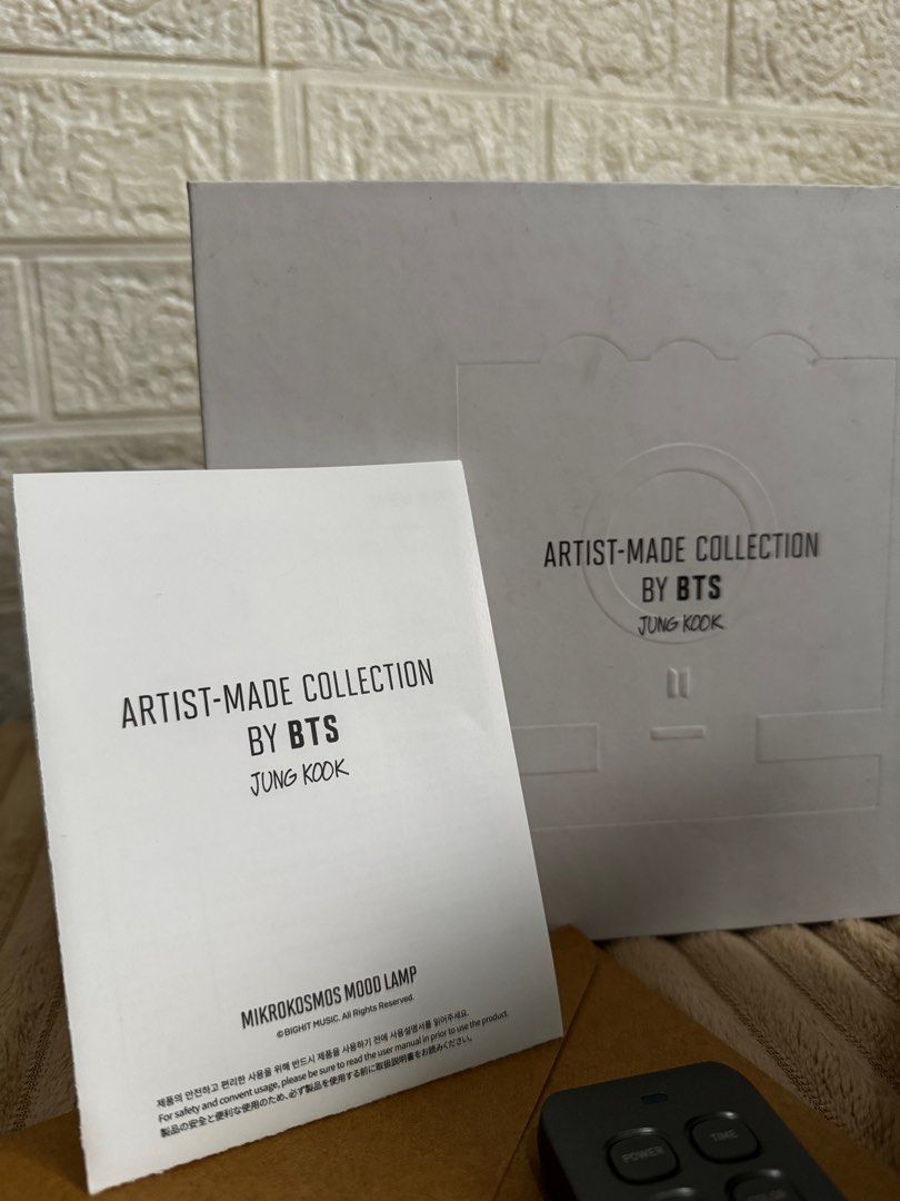 BTS Jungkook Mikrokosmos Mood Lamp (Category: K-Wave Merchandise) located in Valenzuela. Submitted by cheskeyk.1 (Listing ID 1397440023, Image 2). Description: - Artist-Made Collection by BTS Jungkook Mikrokosmos Mood Lamp - Includes: Lamp, Remote Control, Instruction Manual, and Packaging - Packaging features BTS logo and "Artist-Made Collection by BTS Jungkook" - Lamp design: Sleek and modern - BTS logo on the lamp - sealed envelope (photocard 