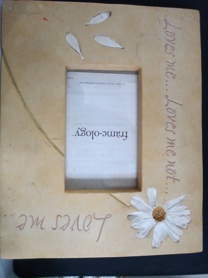 Frame-ology Daisy Photo Frame (Category: Frames & Pictures) located in Cavite. Submitted by hammy18 (Listing ID 1397475177, Image 2). Description: Frame-ology photo frame with daisy design. Square shape, neutral color. Holds one photo. Features "Loves me... Loves me not..." text..