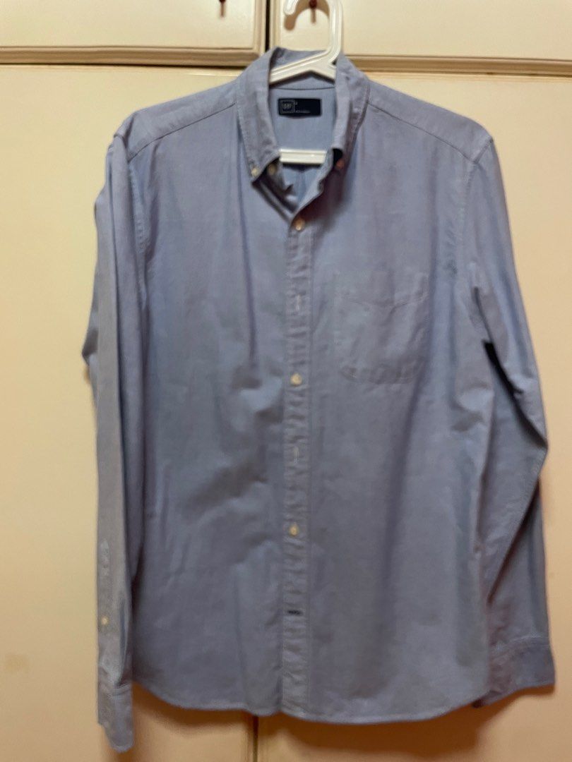 GAP Button-Down Shirt - Blue (Category: Tshirts & Polo Shirts ) located in Makati City. Submitted by masaca (Listing ID 1397442084, Image 1). Description: - GAP blue button-down shirt - Size: Small - Classic collar - Single chest pocket - Long sleeves - Solid color - Made in Indonesia.