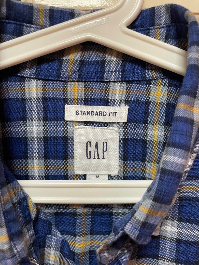 GAP Standard Fit Checkered Shirt (Category: Tshirts & Polo Shirts ) located in Makati City. Submitted by masaca (Listing ID 1397439787, Image 2). Description: - GAP checkered shirt - Color: Blue, white, and tan - Size: M - Features: Button-down collar, single chest pocket - Fit: Standard - Sleeves: Long - Perfect for casual wear.