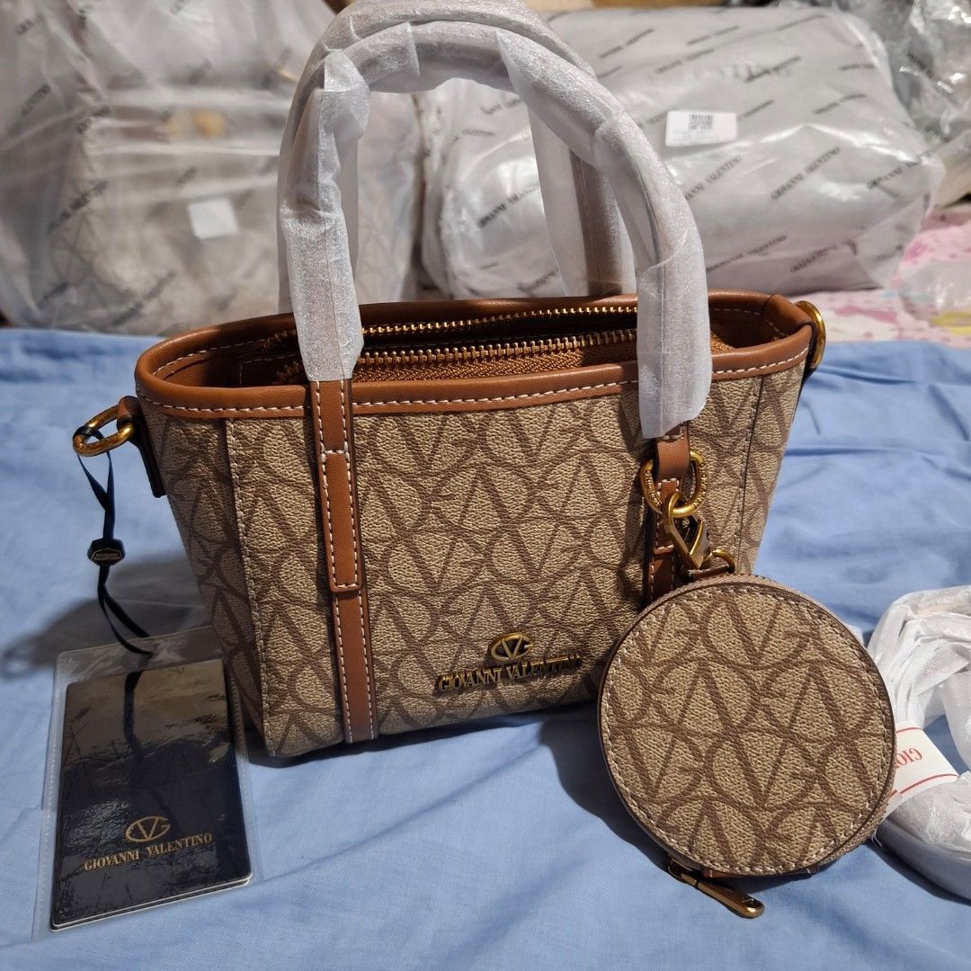 Giovanni Valentino Mini Tote Bag (Category: Cross-body Bags) located in Manila. Submitted by mdc08 (Listing ID 1397522834, Image 2). Description: 🎄🎁 HOLIDAY SALE 🎁🎄 ▪︎Authentic (per source), brand new with tags ▪︎Leather with fabric lining ▪︎Hardware: gold-toned vintage; brand engraved on zipper pulls ▪︎Main compartment with zipper closure, 1 open pocket and 1 zippered pocket ▪︎Dimensions: L 20 x H 14 x W 9 cm ▪︎Retail Price in Yuan: 17,900.0