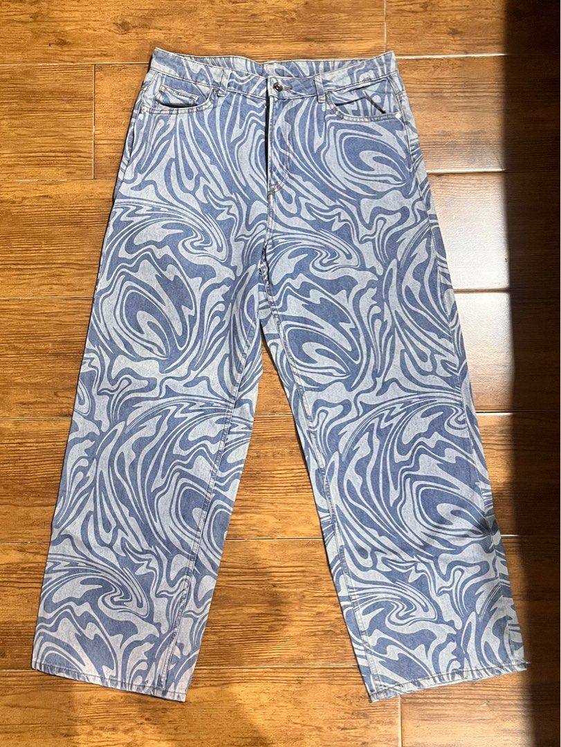 H&M Divided Swirl Printed wide Jeans (Category: Jeans) located in San Juan City. Submitted by lzip888 (Listing ID 1397529776, Image 1). Description: - H&M Divided jeans - Unique swirl print - Wide-leg fit - Classic five-pocket design - Size: EUR 42, US 10, CA 10 - Material: 100% cotton - Perfect for a statement look.