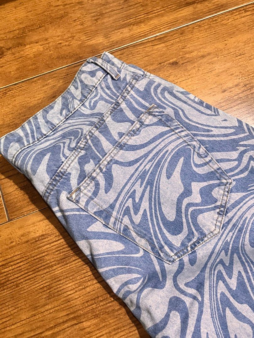 H&M Divided Swirl Printed wide Jeans (Category: Jeans) located in San Juan City. Submitted by lzip888 (Listing ID 1397529776, Image 3). Description: - H&M Divided jeans - Unique swirl print - Wide-leg fit - Classic five-pocket design - Size: EUR 42, US 10, CA 10 - Material: 100% cotton - Perfect for a statement look.