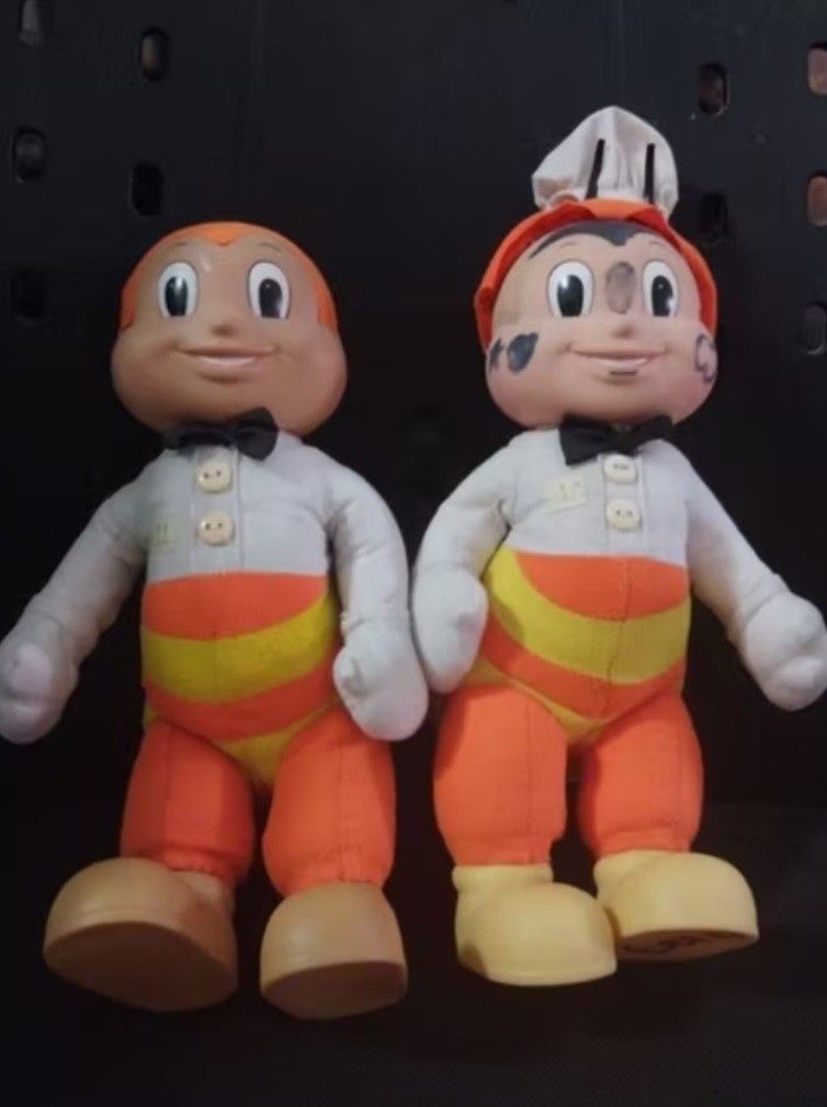 Jollibee Plush Toy Set (Category: Plushies & Soft Toys) located in Abucay. Submitted by g_treasures (Listing ID 1397426433, Image 2). Description: - Set includes two Jollibee plush toys. - One Jollibee is wearing a chef's hat. - Both have orange pants with yellow stripes. - Both have white shirts and black bow ties. - Features tan skin and shoes..