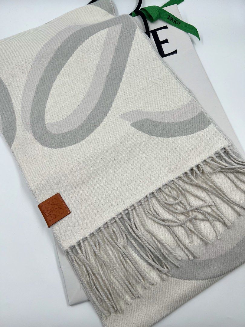 ⚜️Loewe Anagram Fringed scarf (Category: Luxury Accessories) located in Makati City. Submitted by 90sangel (Listing ID 1397573446, Image 3). Description: •Item: Loewe Anagram Fringed Scarf •Size: One size 74" x 10.6" •Condition: Excellent! 💯 *Scarf crafted in medium-weight wool and cashmere blend. Blown-up Anagram jacquard w/ Fringed edges. Anagram embossed placed on the corner. ⚜️ *Very hard to find piece. Japan sourced. 100% 𝒂𝒖𝒕𝒉𝒆𝒏𝒕𝒊𝒄